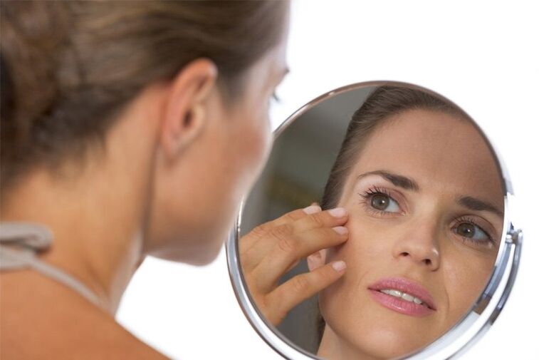 girl looking in the mirror before skin rejuvenation